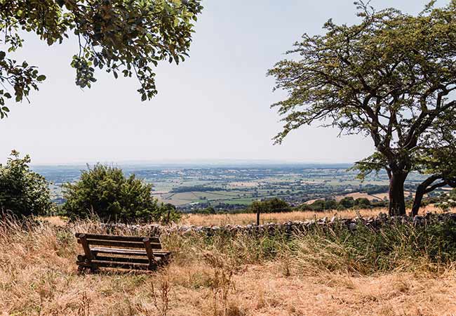 A bench overlooking rolling hills in the Mendip Hills in Somerset